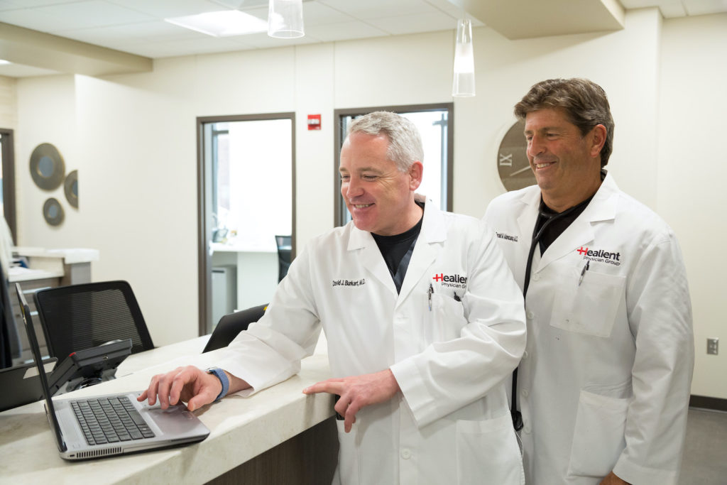 Healient Doctors discussing a patient over a laptop